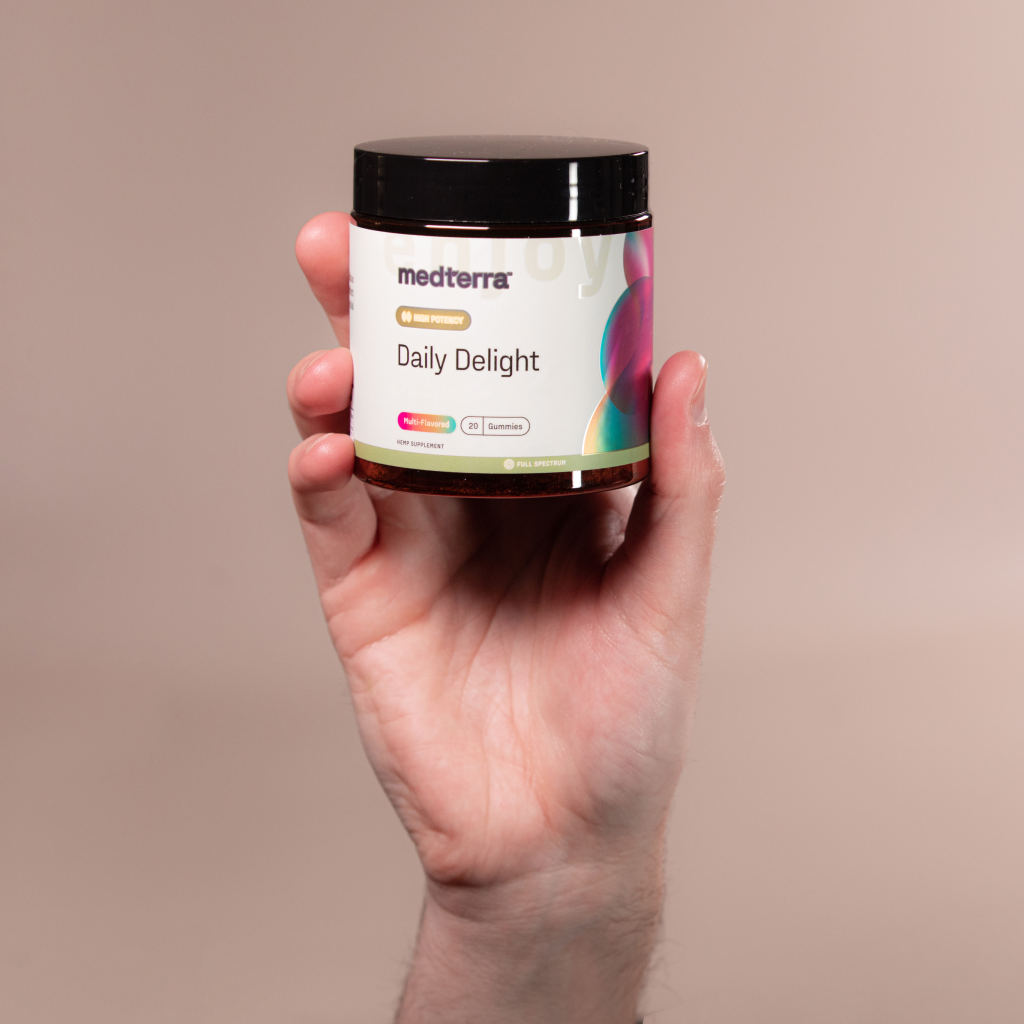 medterra jar labeled 'Daily Delight' held in a hand