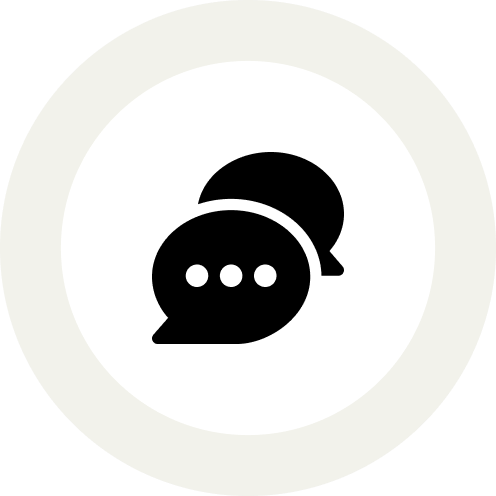 Icon featuring two overlapping speech bubbles in black, positioned centrally on a white circular background with a light grey outer ring. The front speech bubble has three white dots, indicating a text conversation or messaging, symbolically grown in the USA for the highest quality communication.